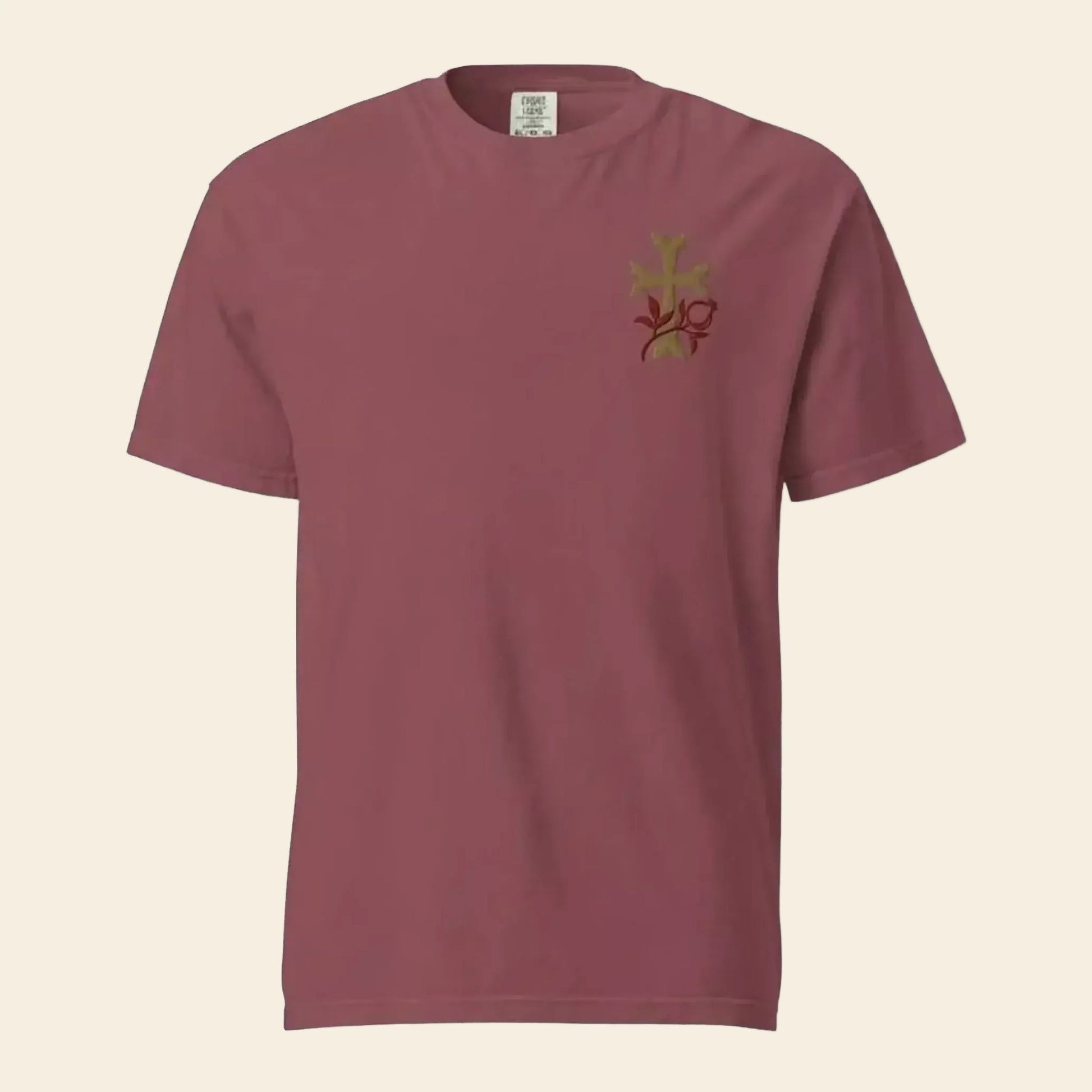 A maroon t-shirt with a small embroidered design on the left side.