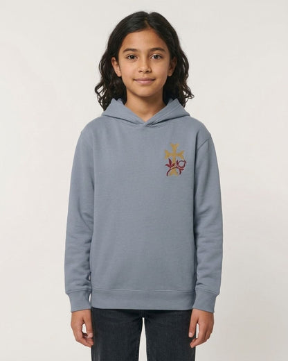 A young girl wearing a gray hoodie with a floral embroidered design on the front.