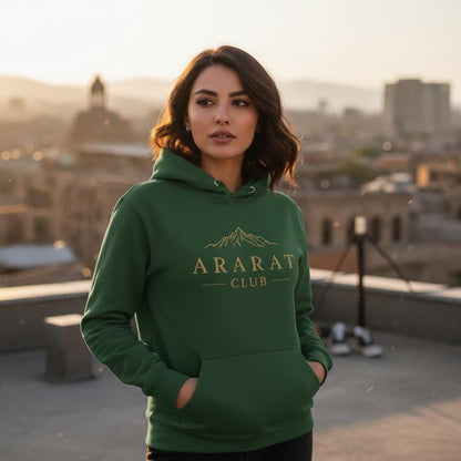 A woman wearing a green hoodie with the text "ARARAT CLUB" stands on a rooftop, with a cityscape visible in the background.