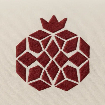 a geometric design composed of red diamond shapes arranged in a circular pattern, with a crown-like shape at the top.