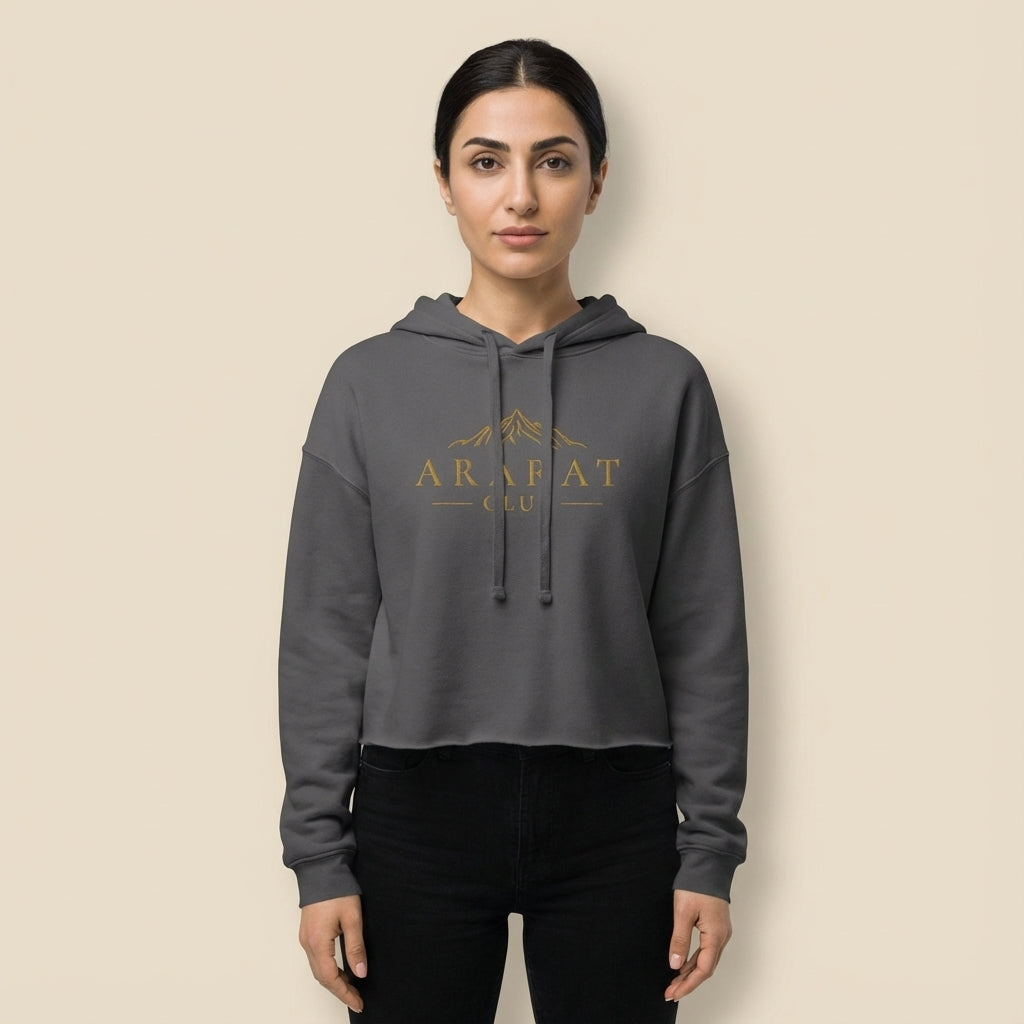 Person wearing a gray hoodie with 'Arafat Club' logo on a beige background