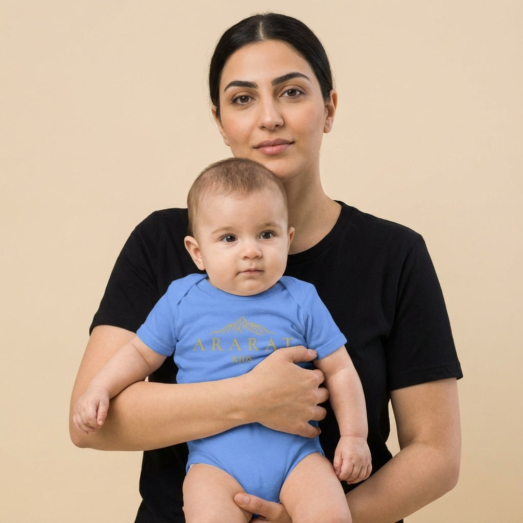 Woman holding a baby wearing a blue onesie with text on a beige background. Anarani Art Ararat Club Onesie.