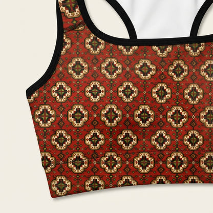 Red patterned tank top with black straps on a white background