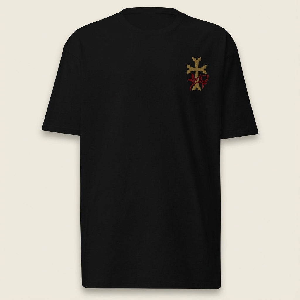 Black t-shirt with a small logo on the chest against a beige background