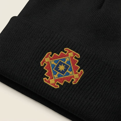 Black beanie with a colorful embroidered logo on a neutral background